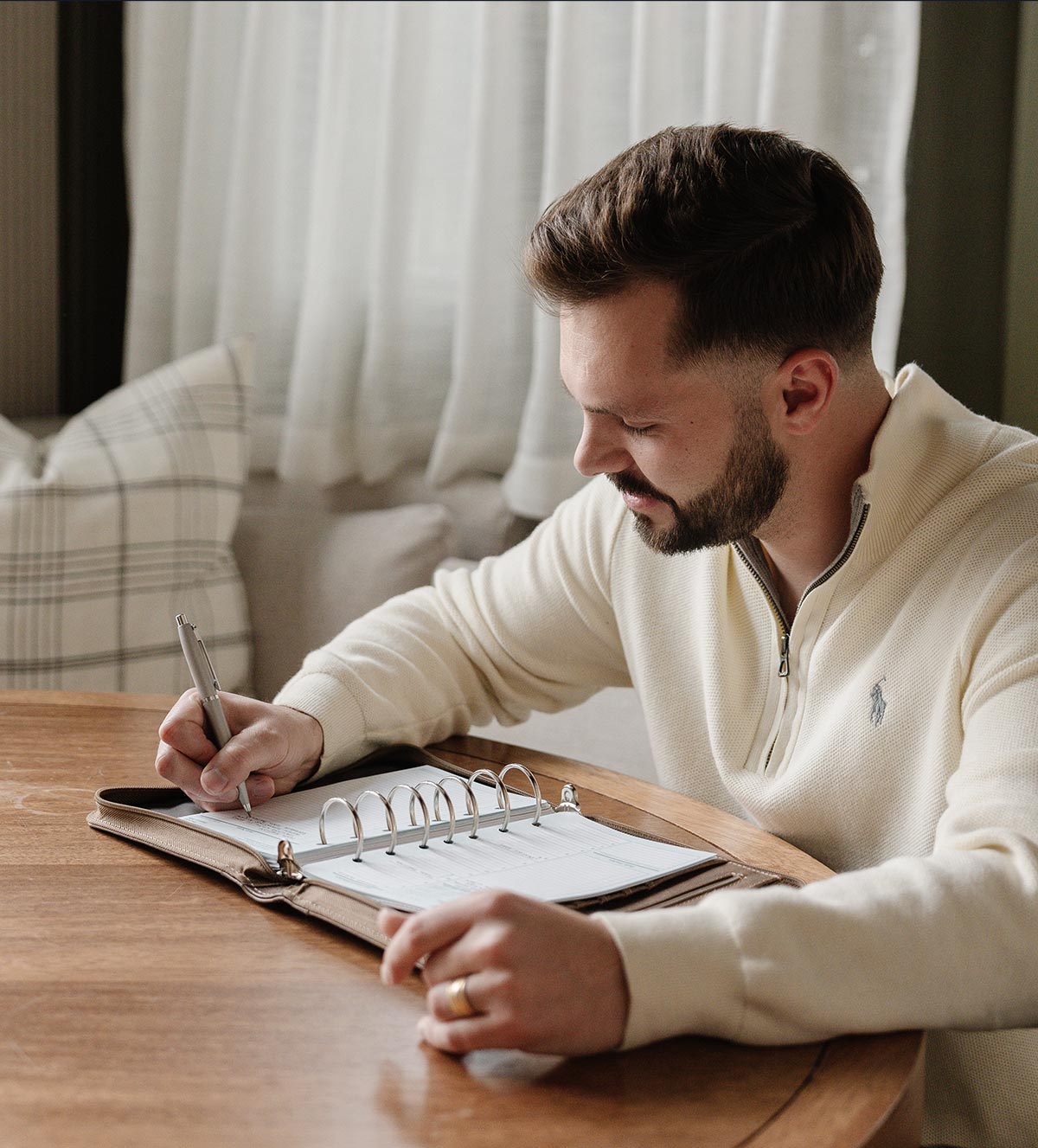 Picture of man writing in his planner.