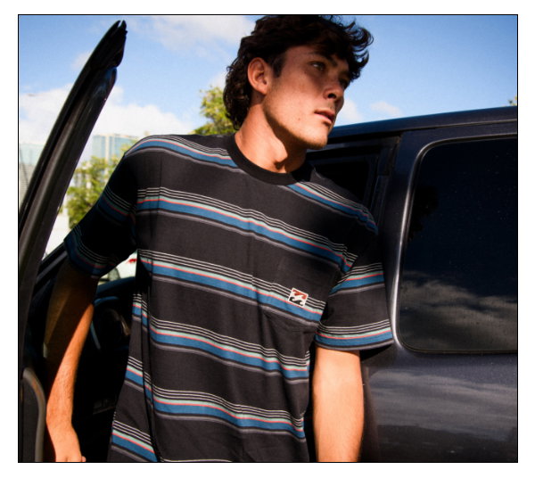 Billabong T-shirt on model getting out of a car
