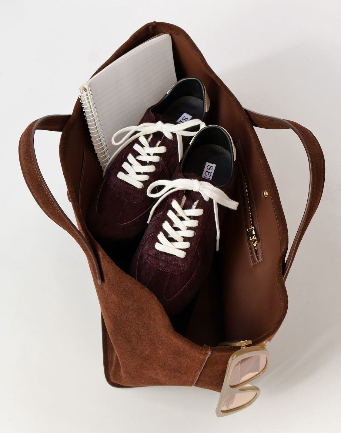 Pile of three ACE sneakers stacked on top of eachother