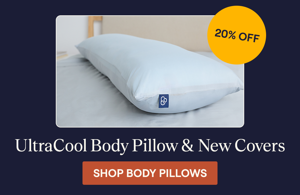 An UltraCool Body Pillow laying on a bed