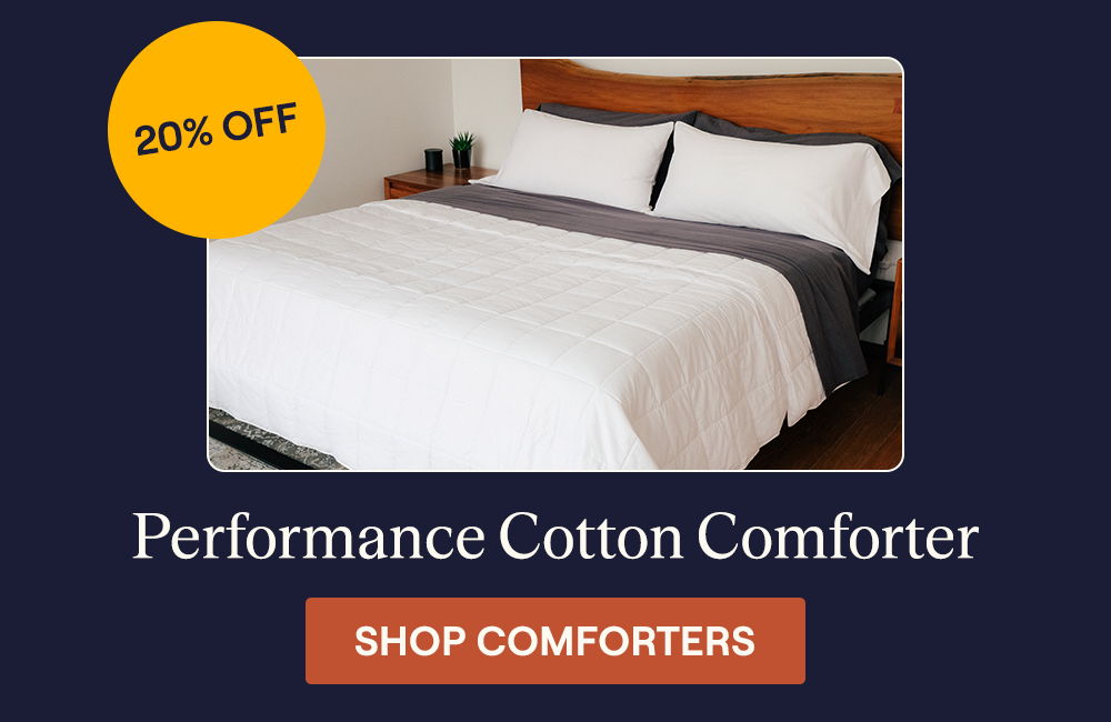The Lightweight Performance Cotton Comforter on a bed