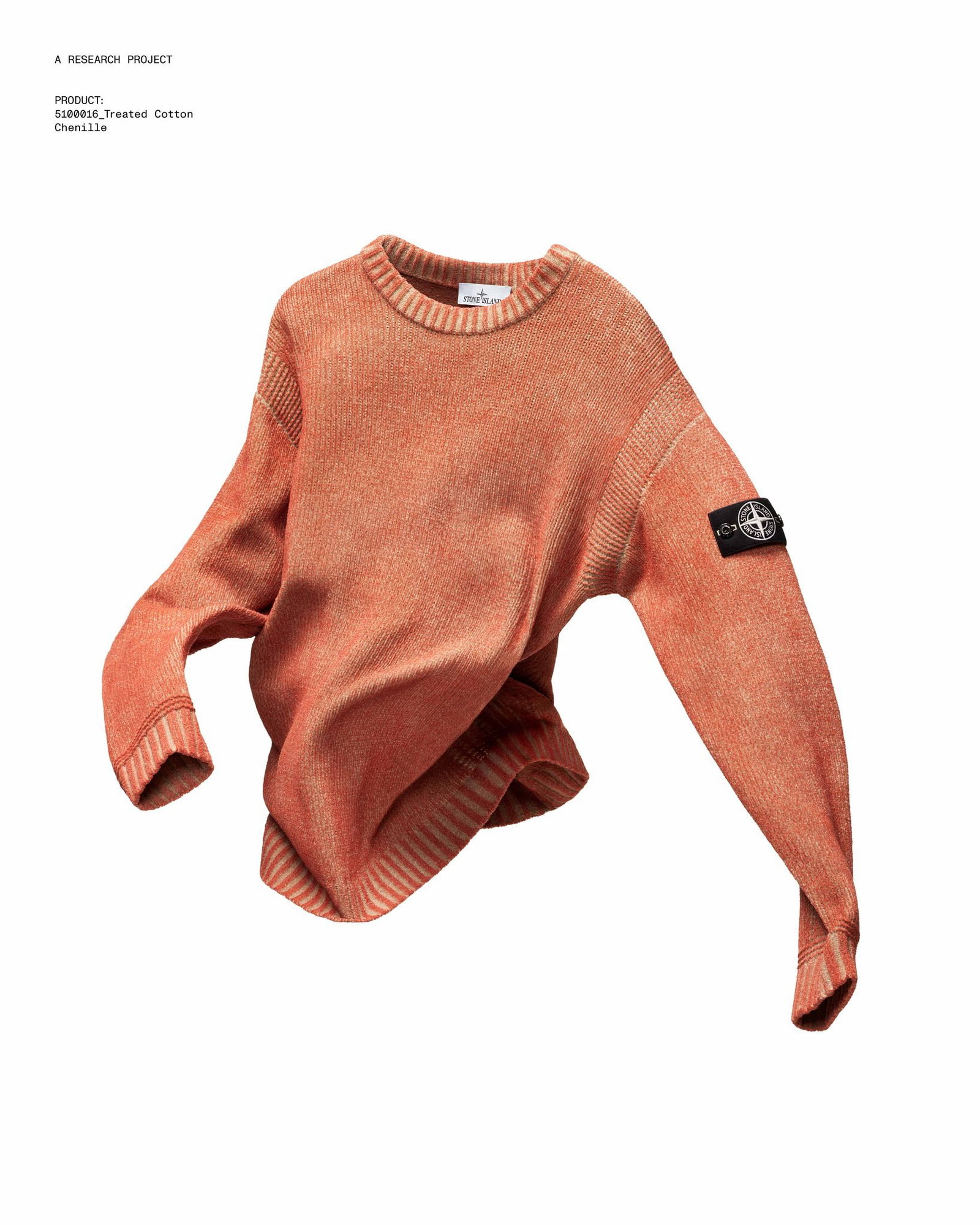 Faded orange cotton crewneck sweater with ribbed cuffs and hem, floating pose, black compass patch on left sleeve