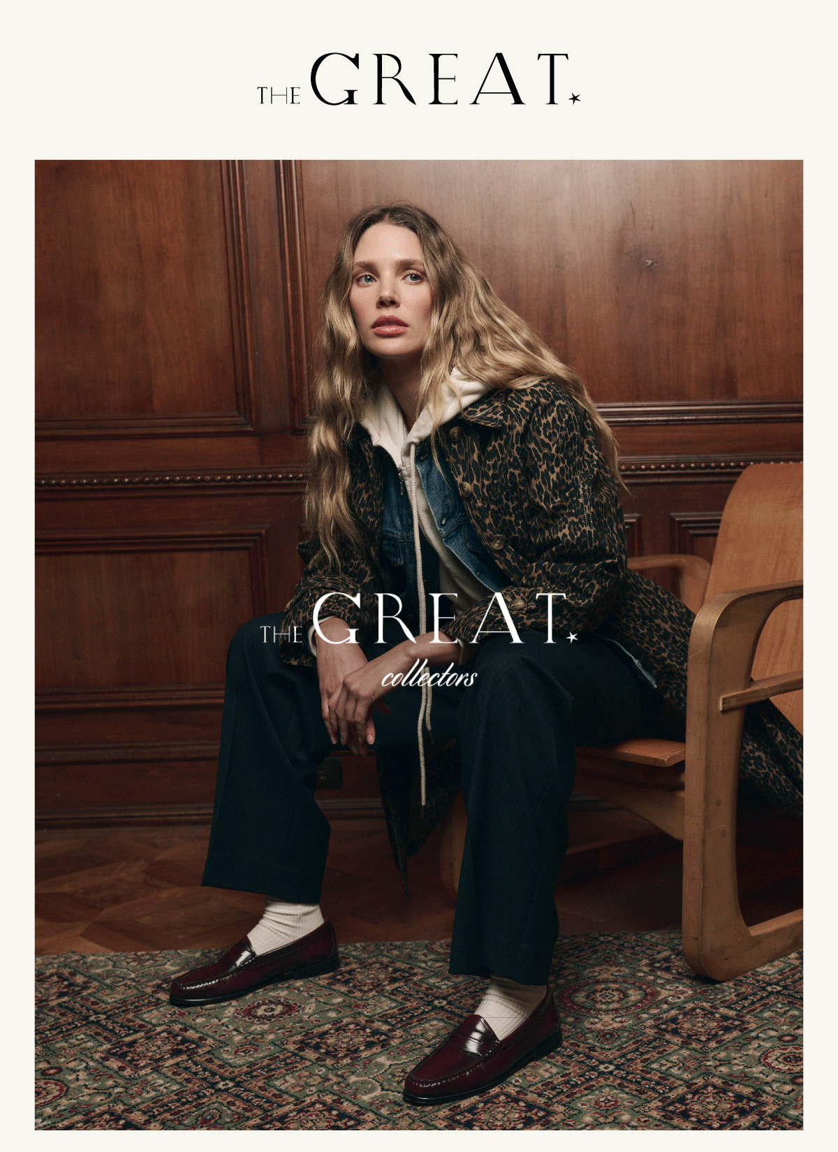 A woman with long wavy hair sits on a wooden chair in a paneled room, wearing a leopard print coat, denim jacket, white hoodie, black pants, and burgundy loafers. “The Great collectors” is written on the image.