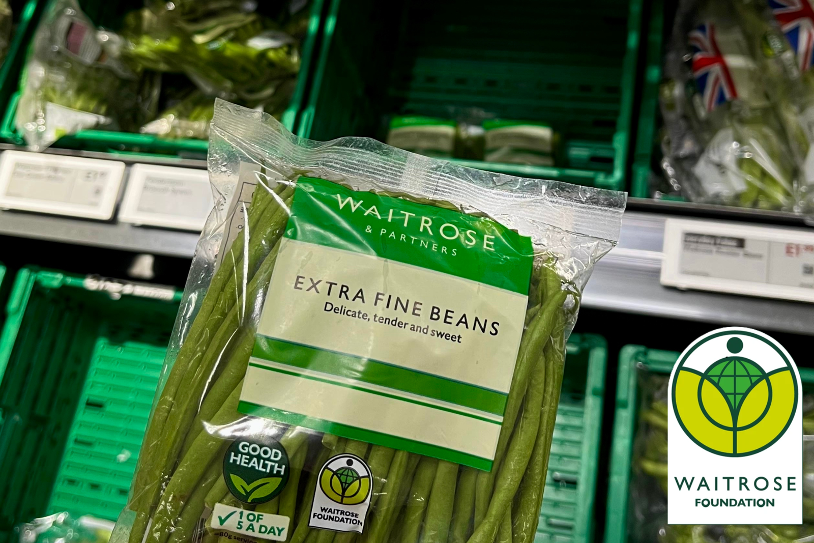an image of green beans in plastic packaging being held up to the camera, with the “Waitrose foundation” logo visible on the packaging.