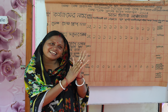 a woman stood in front of a whiteboard.