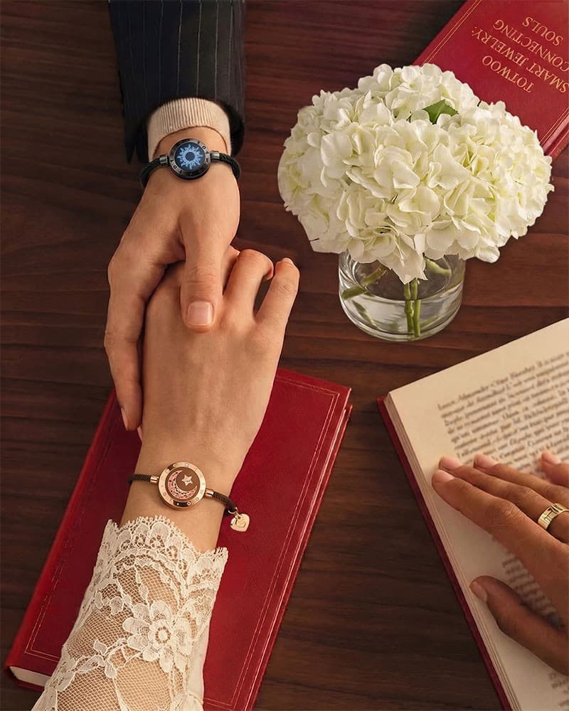 A couple wearing Sun and Moon touch bracelets
