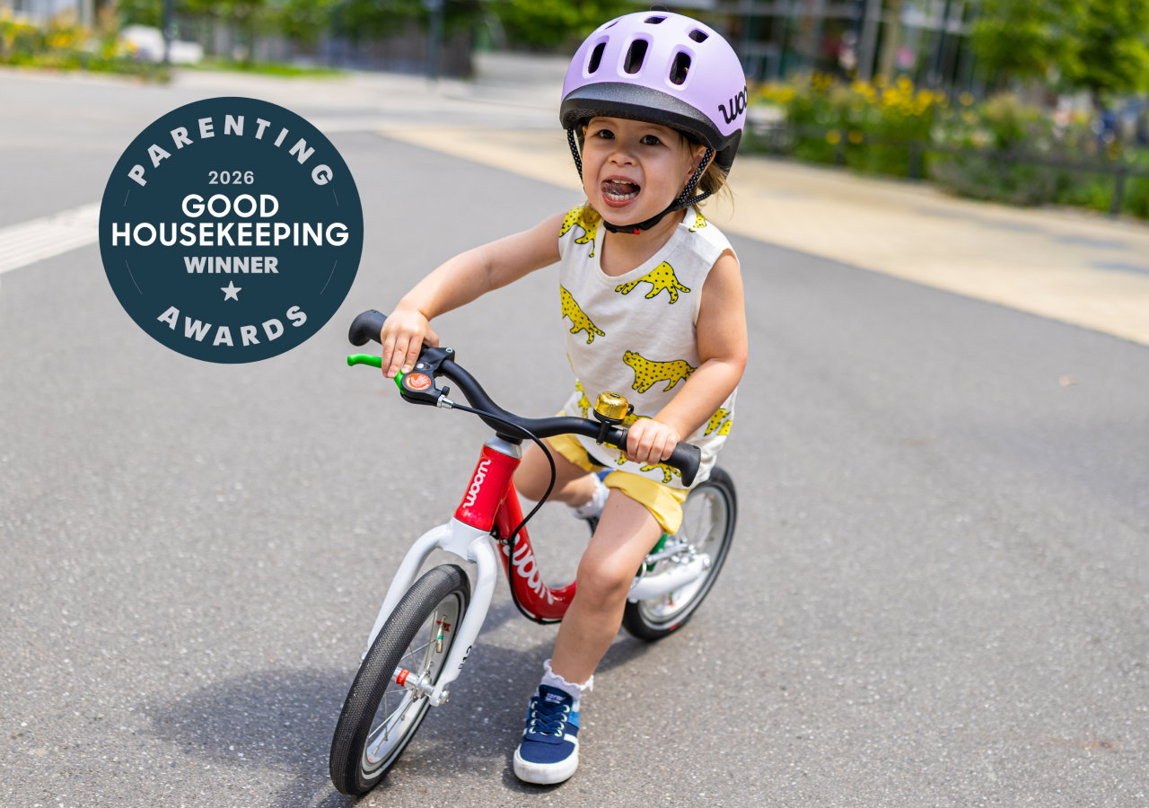 Child on a woom GO 1 next to a Good Housekeeping award