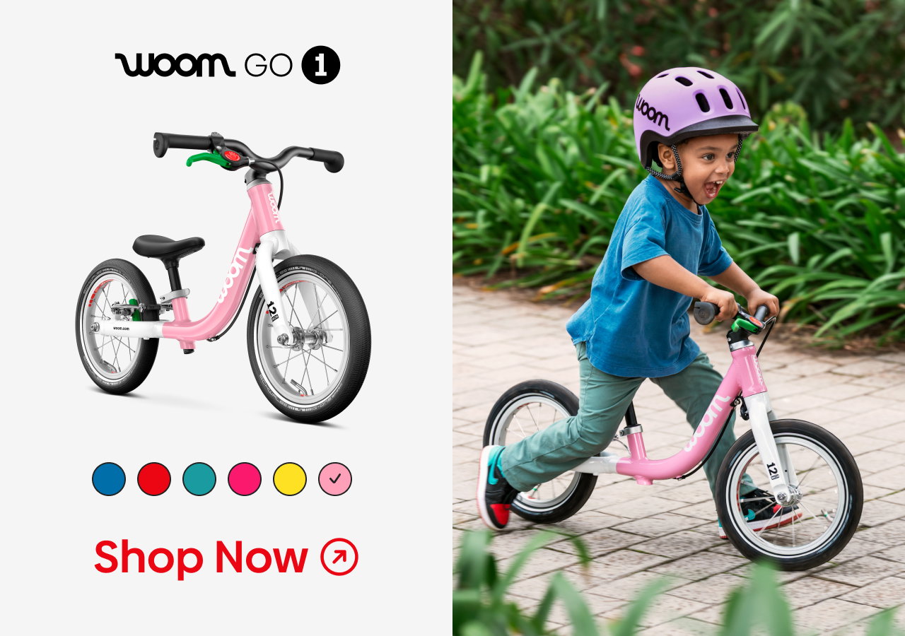 An image of a young boy riding a powder pink woom GO 1 next to a product visual of the same bike, with additional colors shown underneath and a "Shop Now" callout.