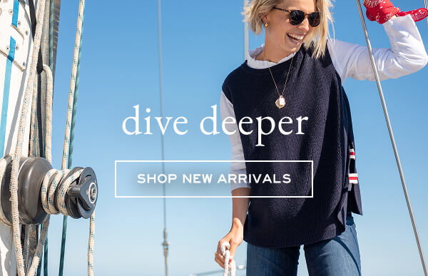 Dive Deeper - Shop new arrivals - Image of woman wearing a sweater on boat. 