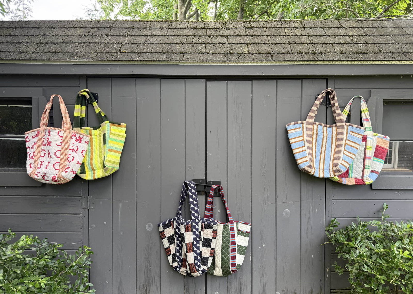 quilted bags hanging on garage doors