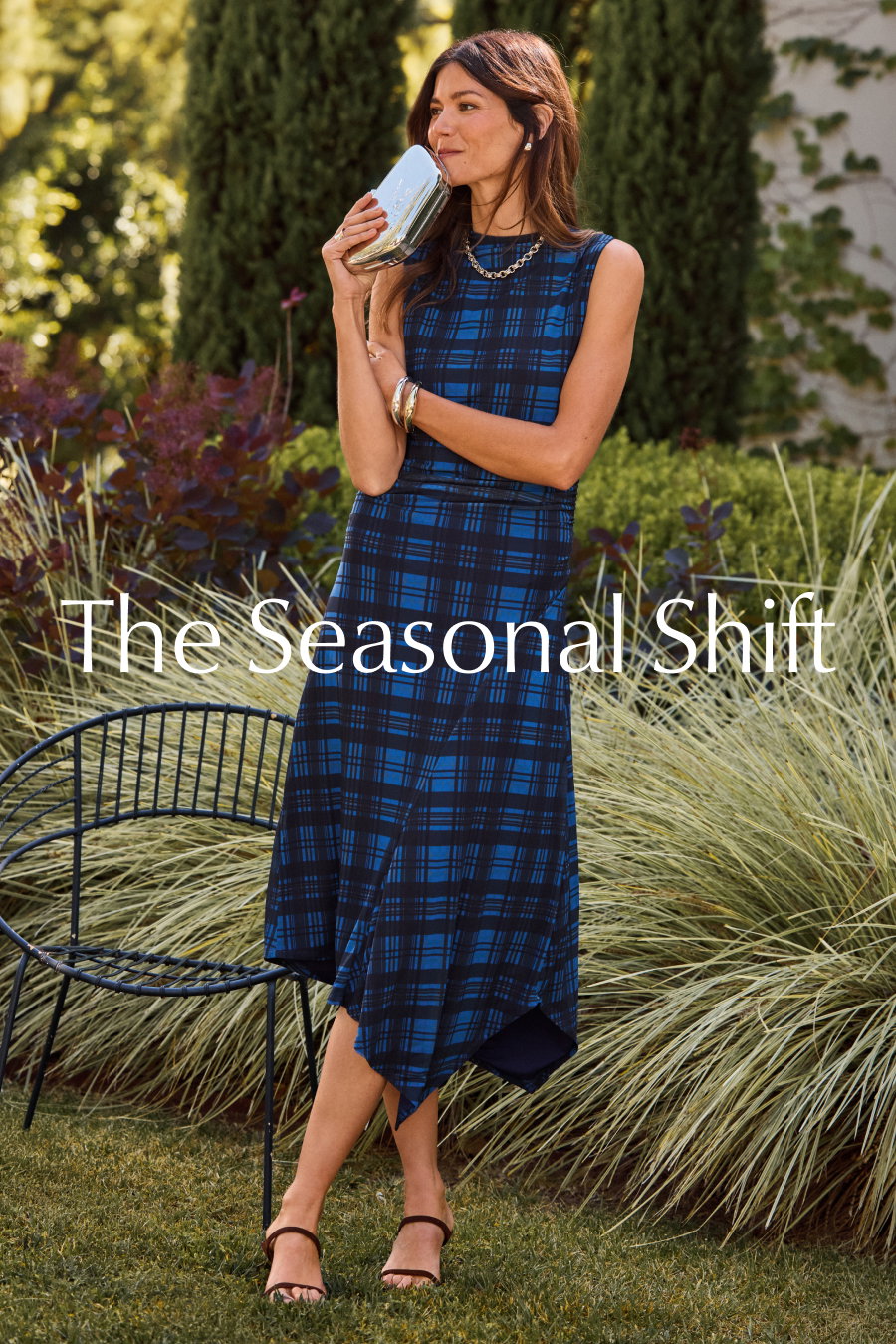 The Seasonal Shift. Image of fashion model in field wearing stylish plaid dress from EVEREVE.