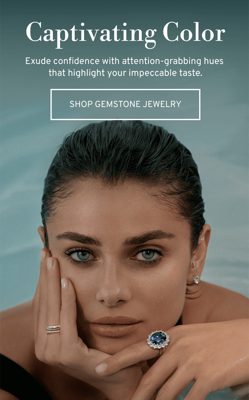 Model in a pool wearing a statement sapphire ring. Captivating color. Click to Shop Gemstone Jewelry