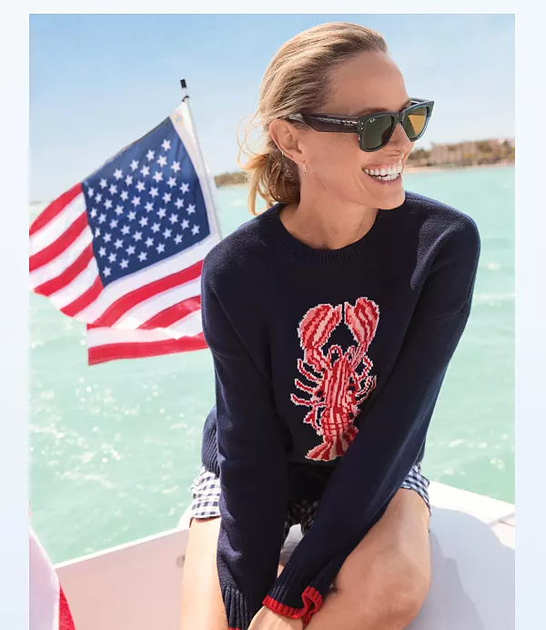 A woman in a lobster sweater. 