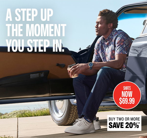 Model sitting in the open door of a classic car wearing a patterned short-sleeve shirt, jeans, and the Ackerson Plain Toe sneaker. Text reads: 