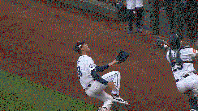 An animated gif of Cal Raleigh making a sliding catch in foul territory
