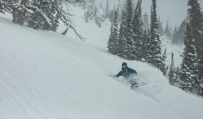 Snowboarder riding down mountain