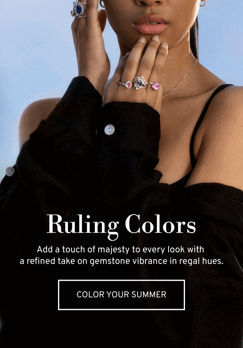 Model wearing several statement gemstone rings. Add a touch of majesty to every look. Click to Shop Summer Colors