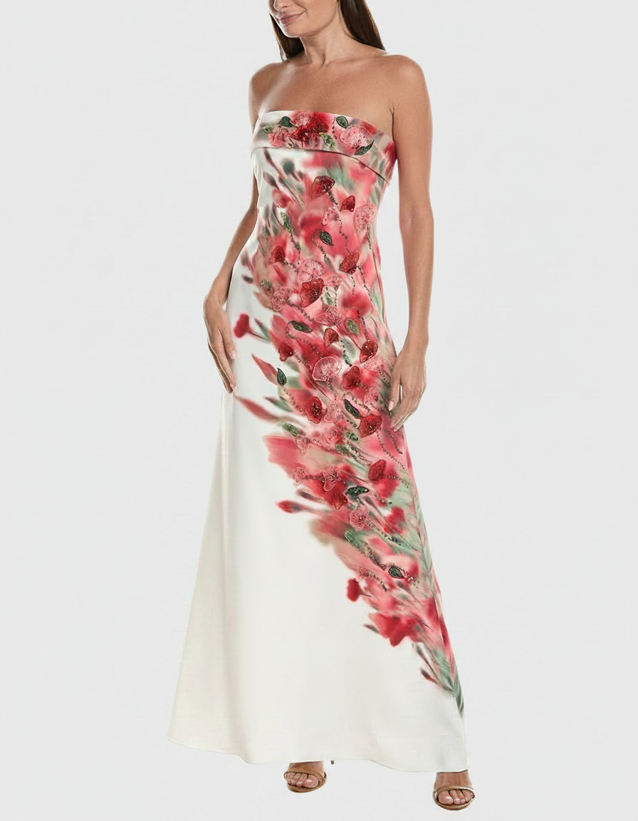 Woman in a strapless white gown with a vibrant red floral print.