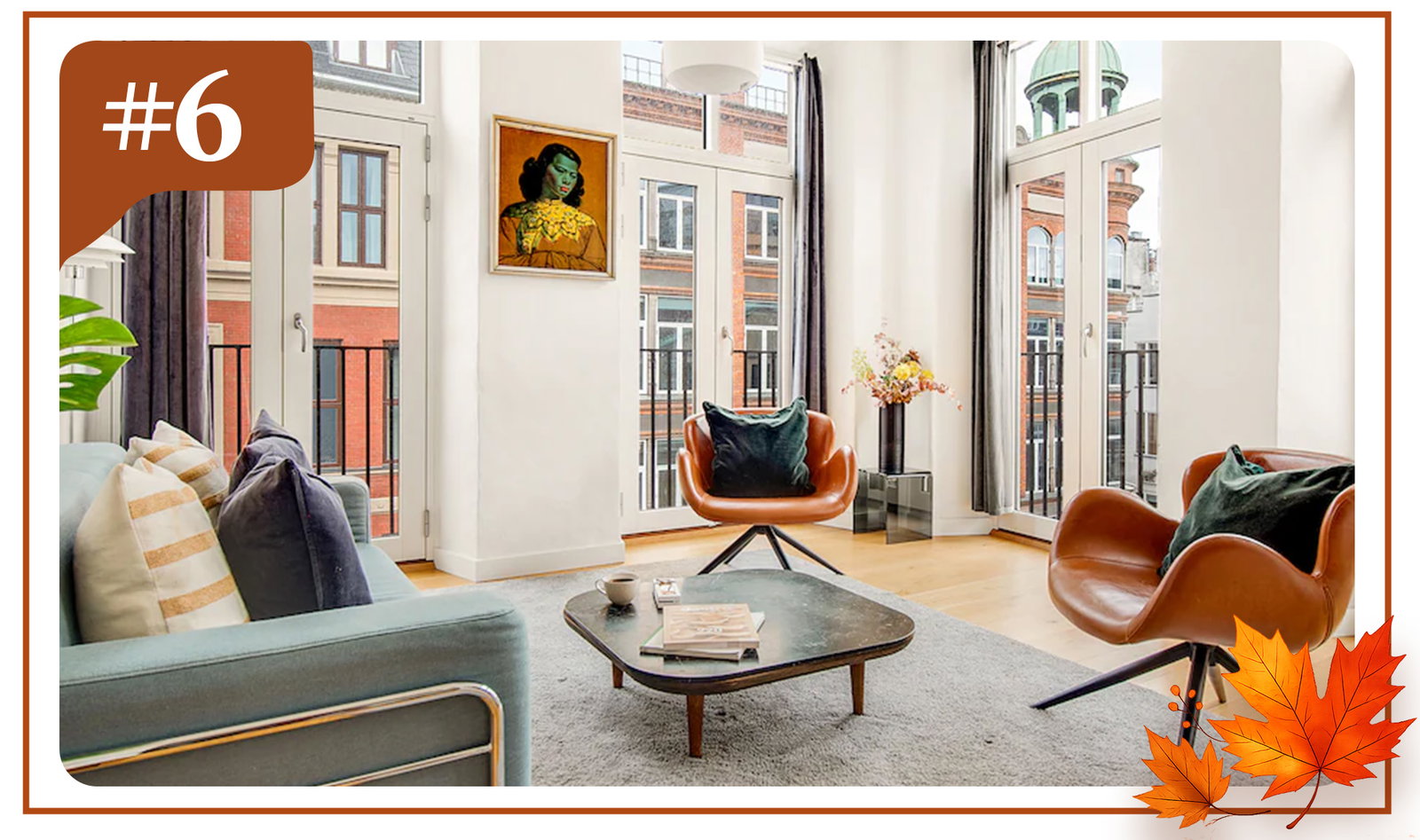Light-filled living space with soaring windows, curated décor, and views of historic city rooftops.
