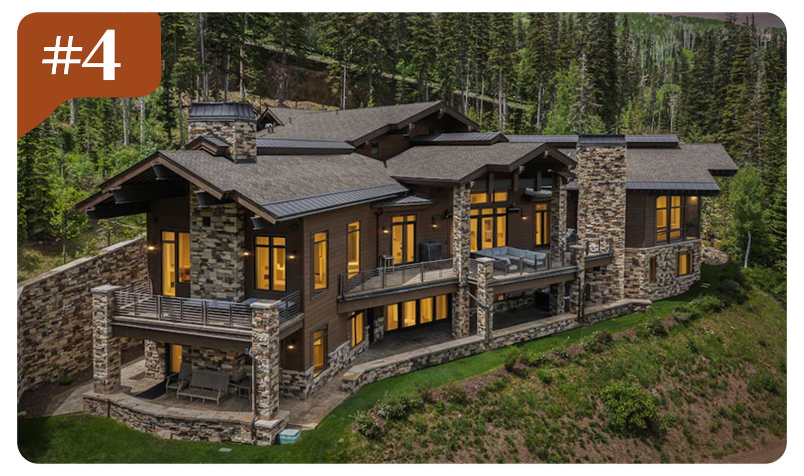 Grand alpine retreat tucked into the mountainside, with sweeping views and expansive terraces.