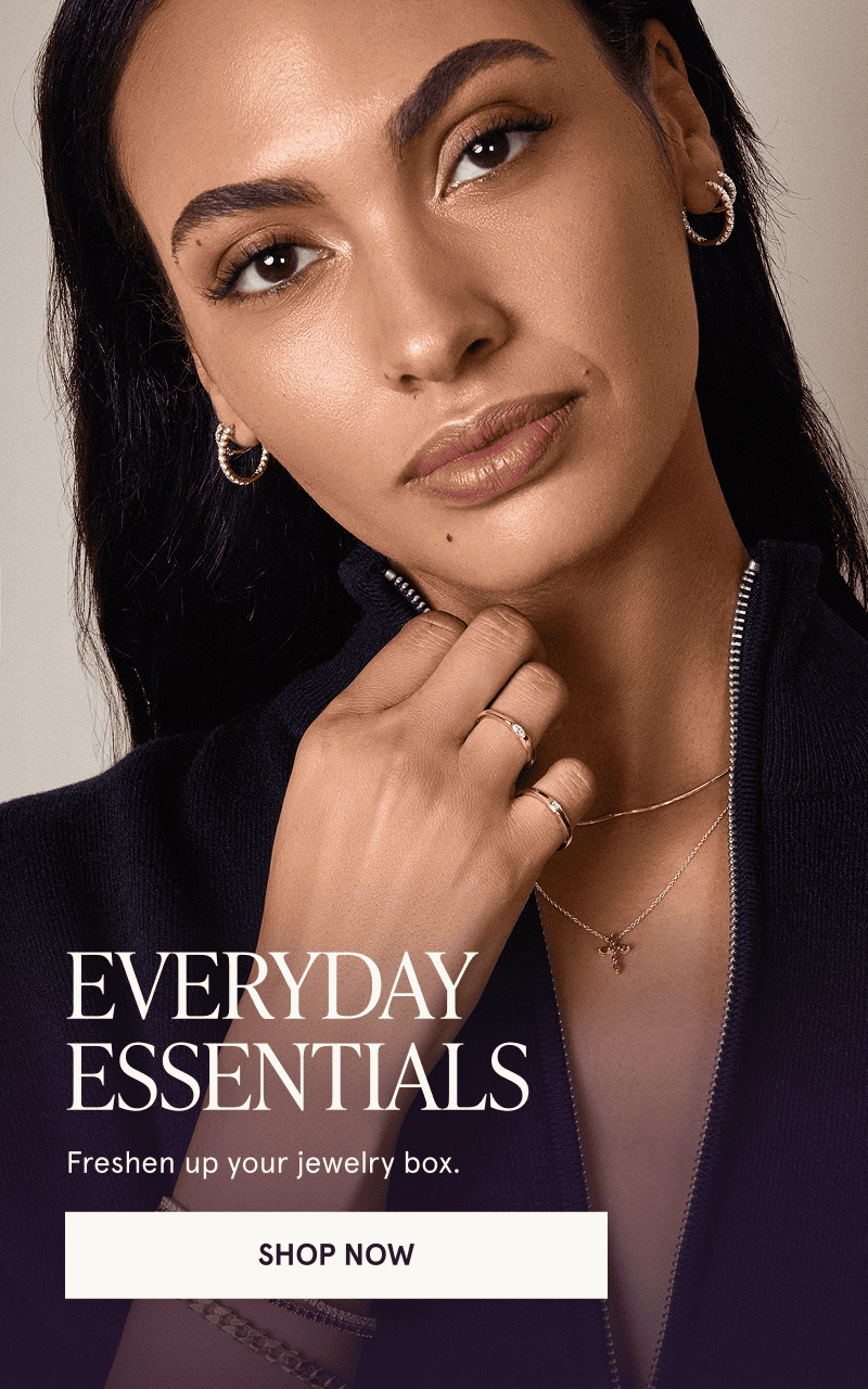 A model wearing gold diamond and gemstone jewelry. Everyday essentials. Click here to shop now