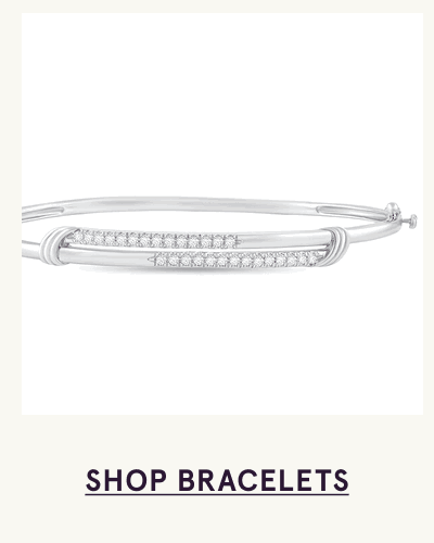 Sleek silver bangle bracelet with dual horizontal bars covered in pavé stones. Click here to shop bracelets