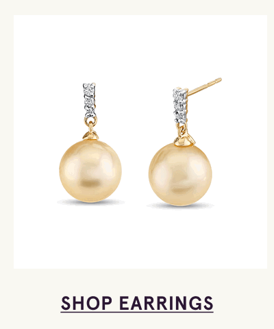 Gold drop studs with gold pearls hanging from diamond-encrusted posts. Click here to shop earrings