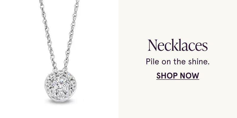A white metal necklace with a circular white gemstone pendant. Pile on the shine. Click here to shop necklaces
