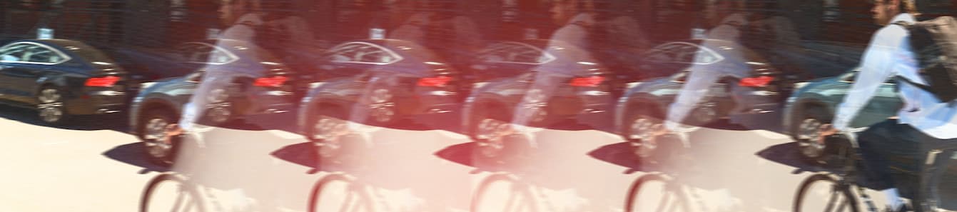 A blurred picture of a guy riding a bike repeated wearing a coming soon Recruit 22L Pack