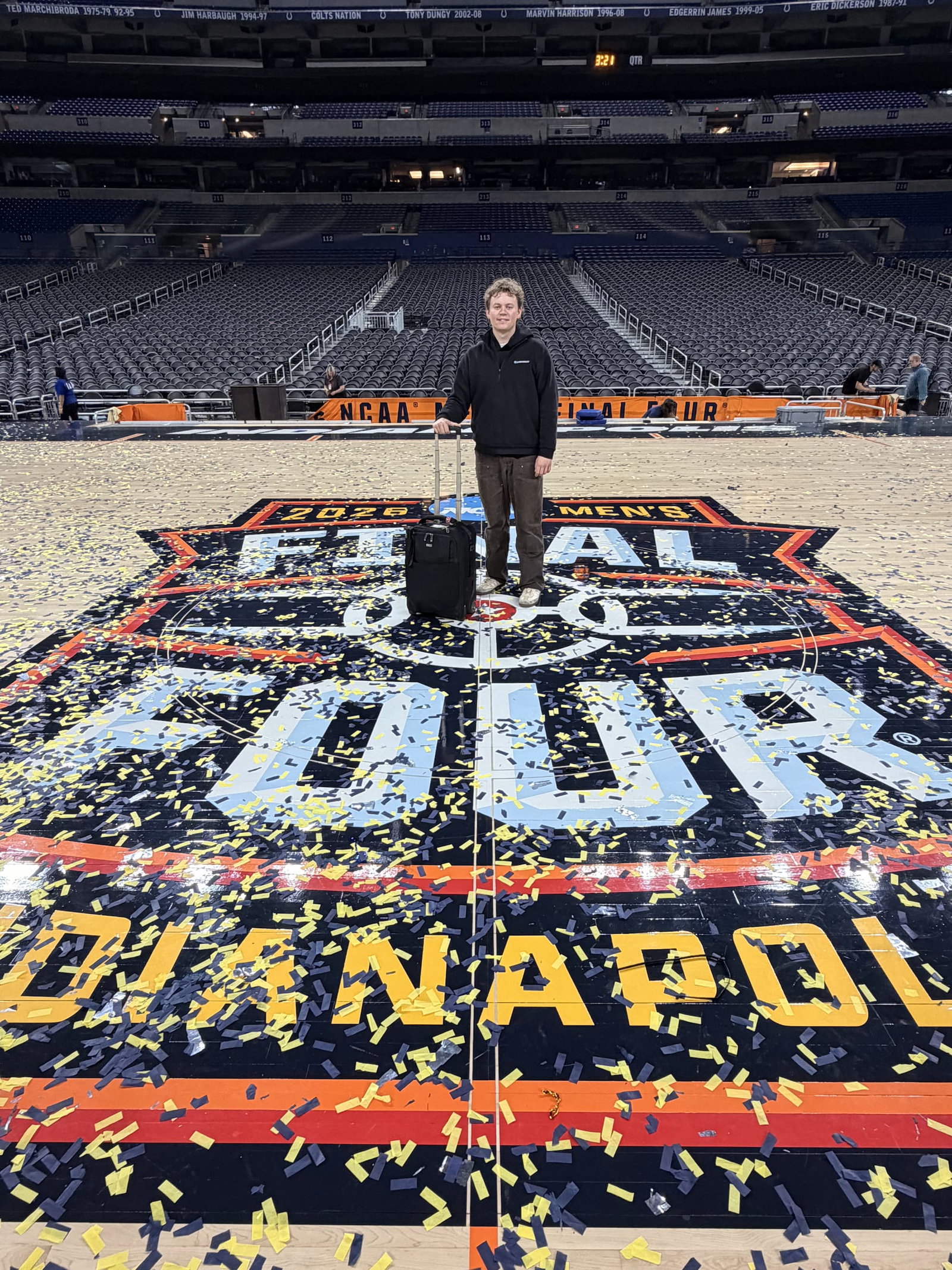 Tanner Pearson stands on the court covered with confetti at the 2025 NCAA Men’s Final Four, holding his Think Tank roller.