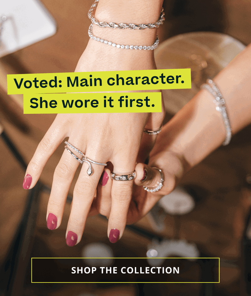 Hand with silver & cubic zirconia bracelets & ring stack. Main character. Click here to shop the collection