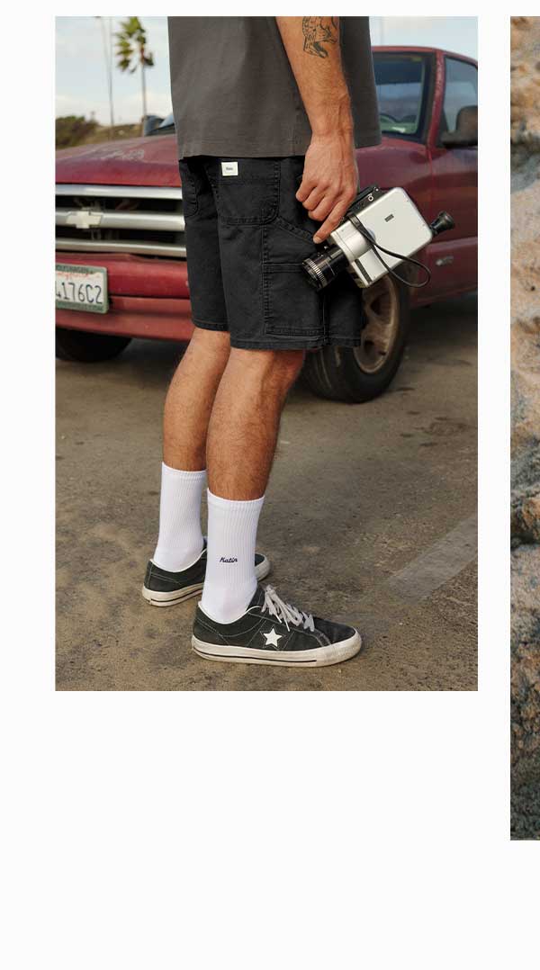 Male model wearing our Stanley Shorts in Black