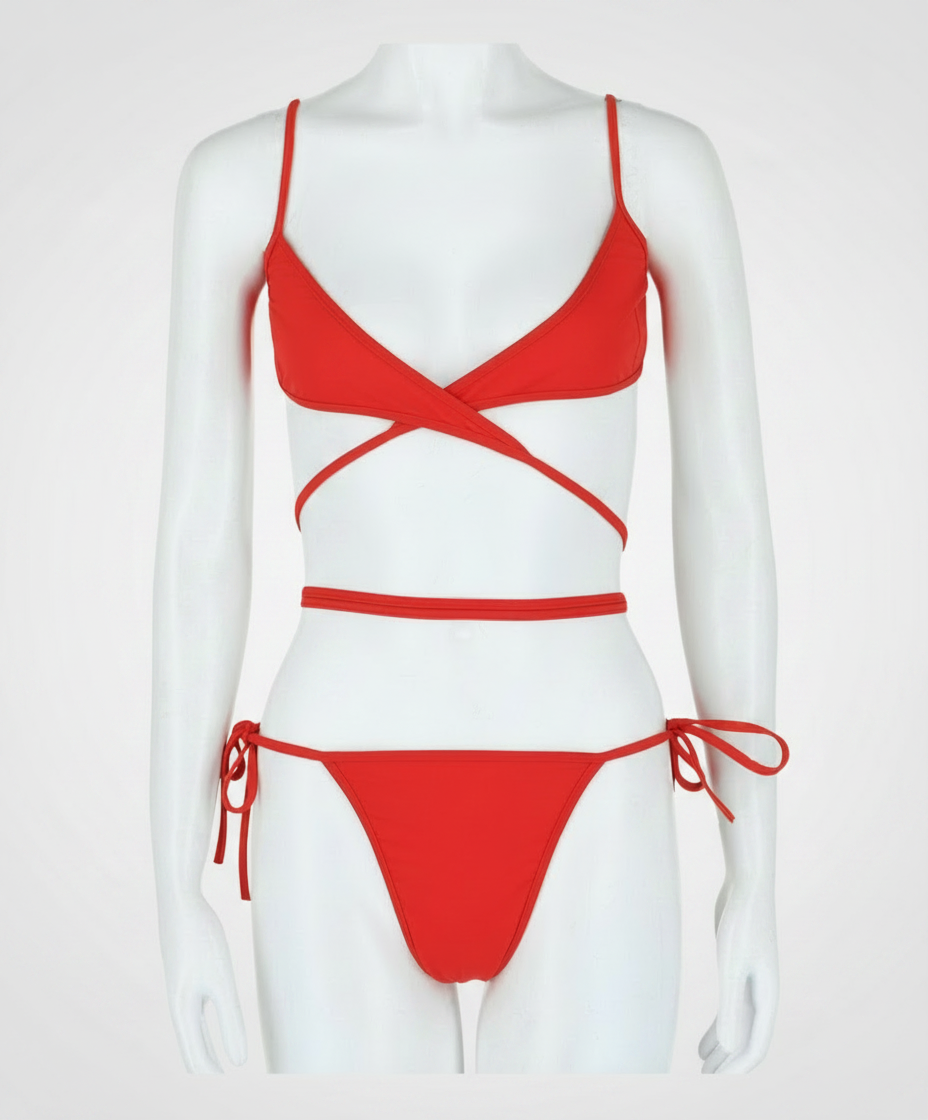 Red bikini with criss-cross straps and tie-side bottoms on a mannequin.