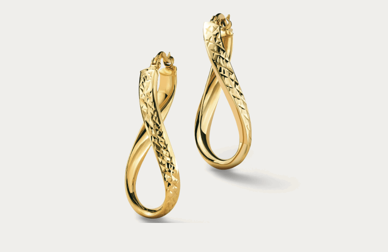Twisted yellow gold drop earrings with faceted and polished finishes.