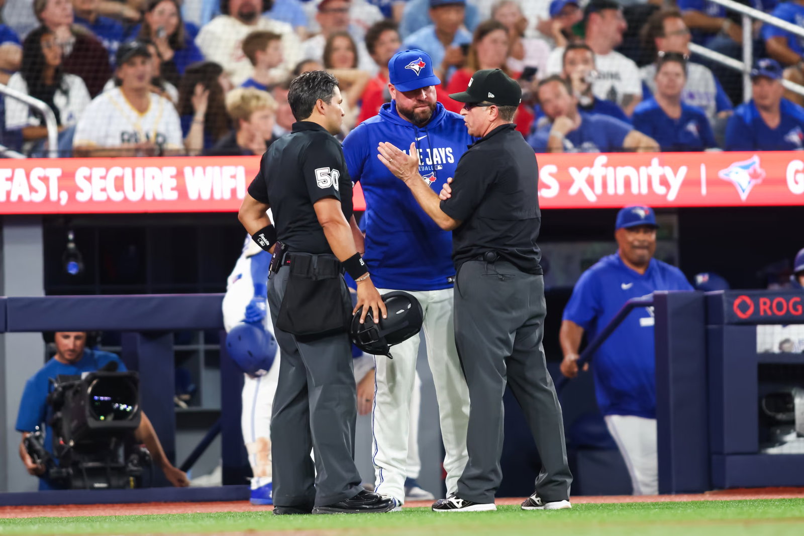 The umpires explain the rule review to Blue Jays manager John Schneider