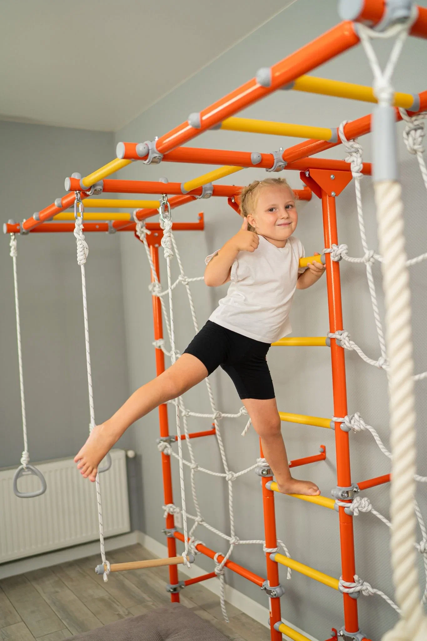 Children playing on a wall-mounted Brainrich home play gym