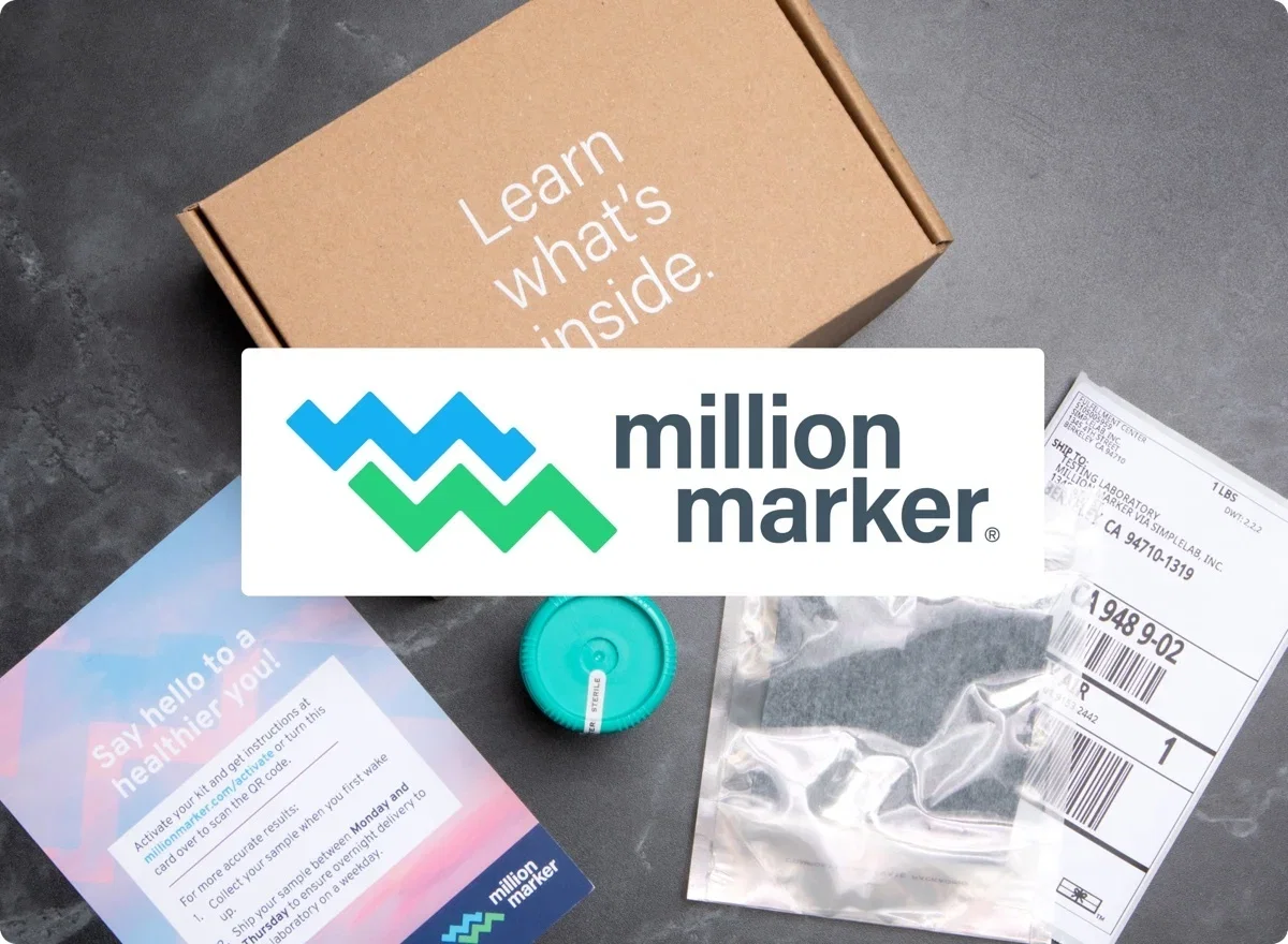Million Marker mail-in test kit: kraft box, teal sample cup, instructions card, and return mailer