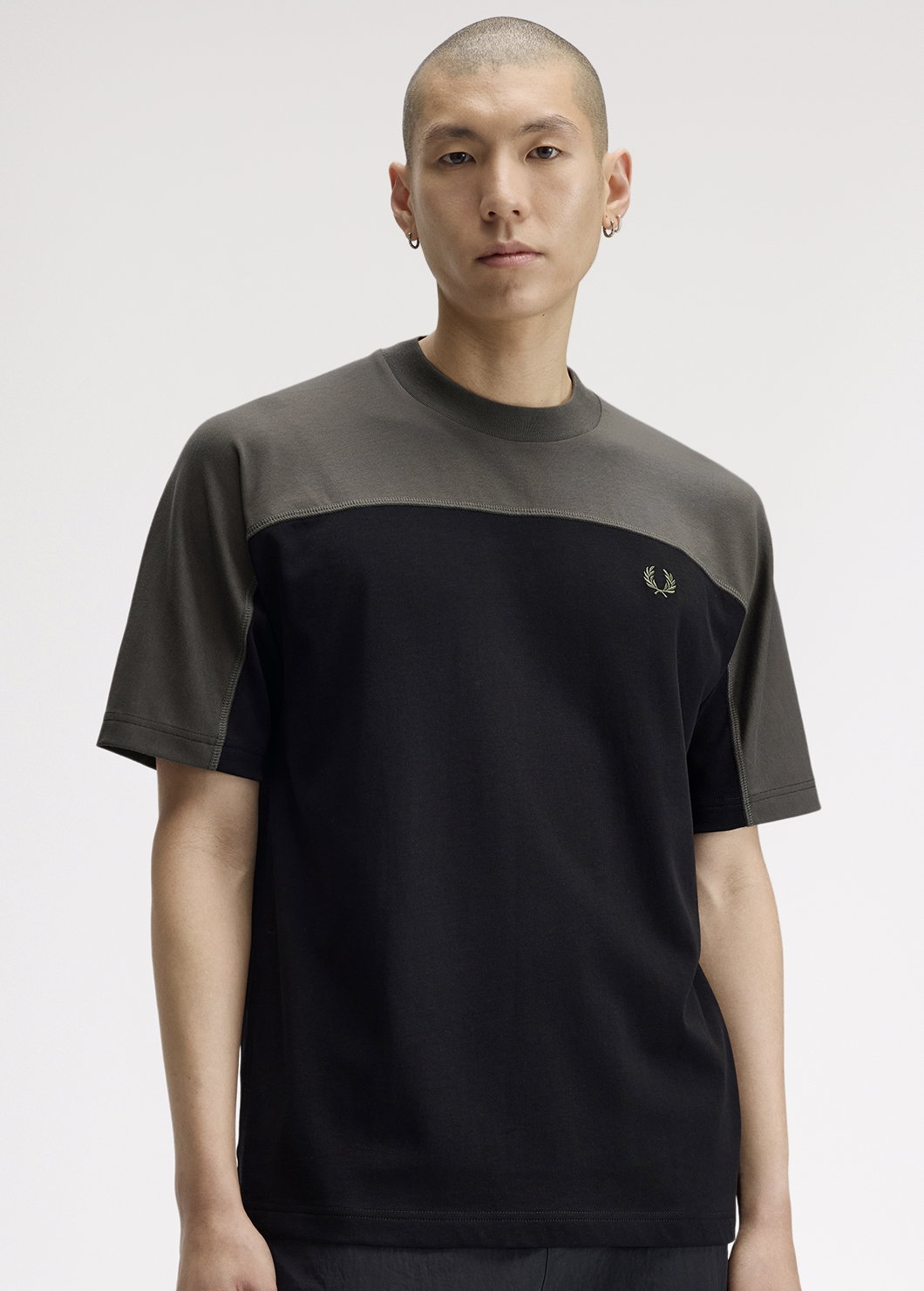 A male model wearing a Fred Perry Relaxed Fit Colour Block T-Shirt in Black