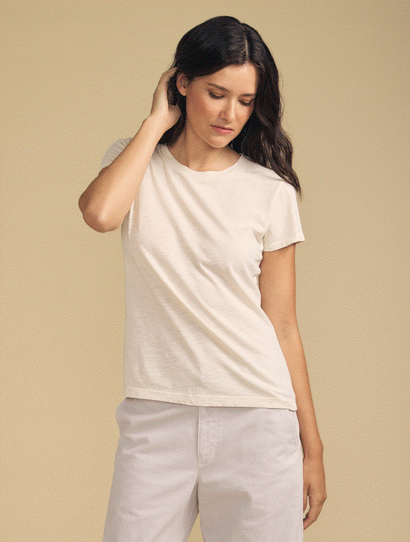Image of model wearing Odelia in Beach. Text reads: Classic Crew Neckline. Short Sleeve. Flattering Drape.