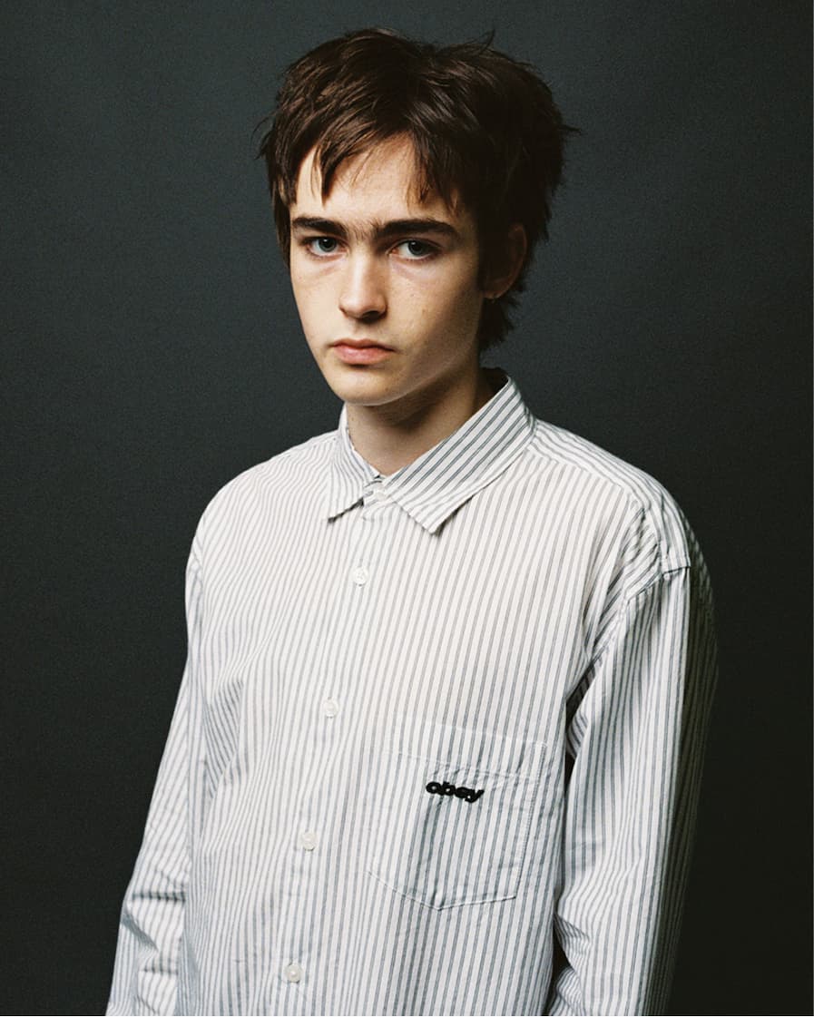 Male model wearing button up shirt with stripes from Obey
