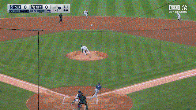 An animated gif of George Lombard Jr. adjusting to a bad bounce to grab a grounder with his bare hand and throw to first