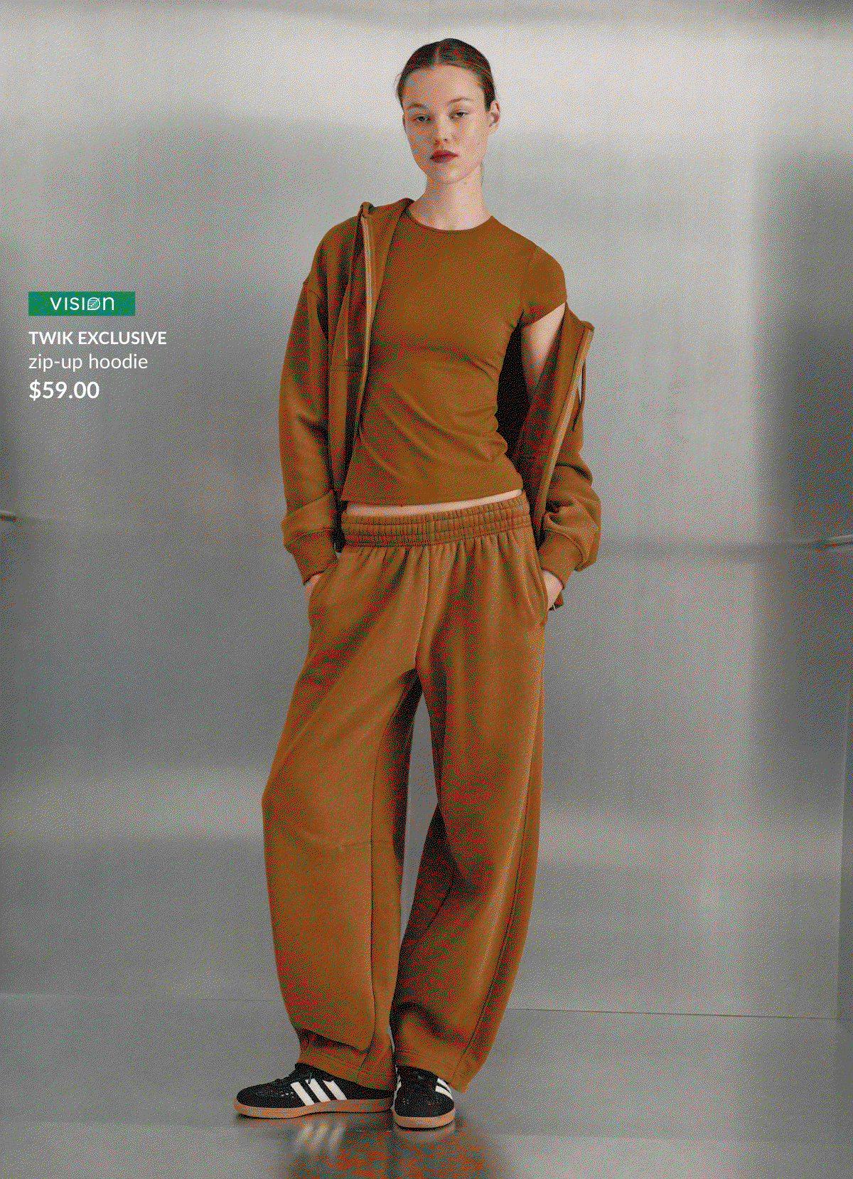 Young woman wearing a Twik exclusive coffee-brown zip-up hoodie, $59