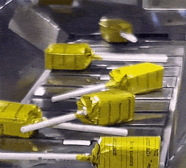 Animated GIF of Lemonade Lollypops traveling on a factory conveyer belt