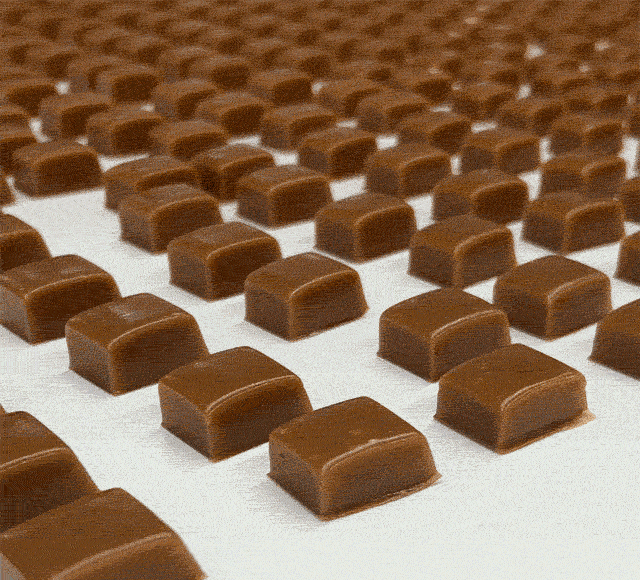 Animated GIF showing caramel candies on a conveyer belt
