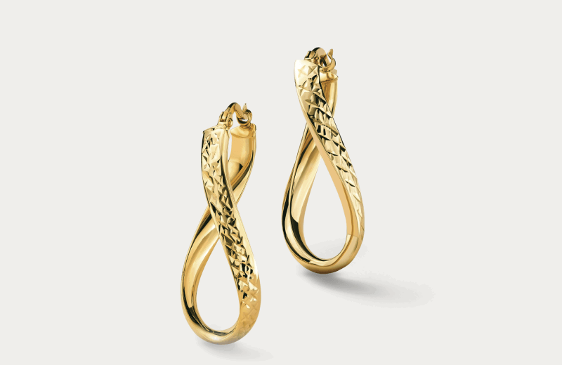 Yellow gold twisted teardrop hoop earrings with diamond-cut detailing.