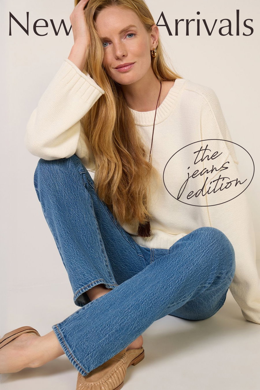 New Arrivals: The Jeans Edition. Image of fashion model in sweater and sale jeans. 