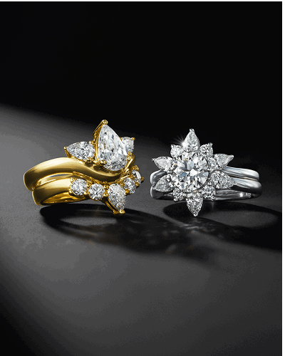 A yellow and white gold stacked diamond engagement rings on a dark background. 