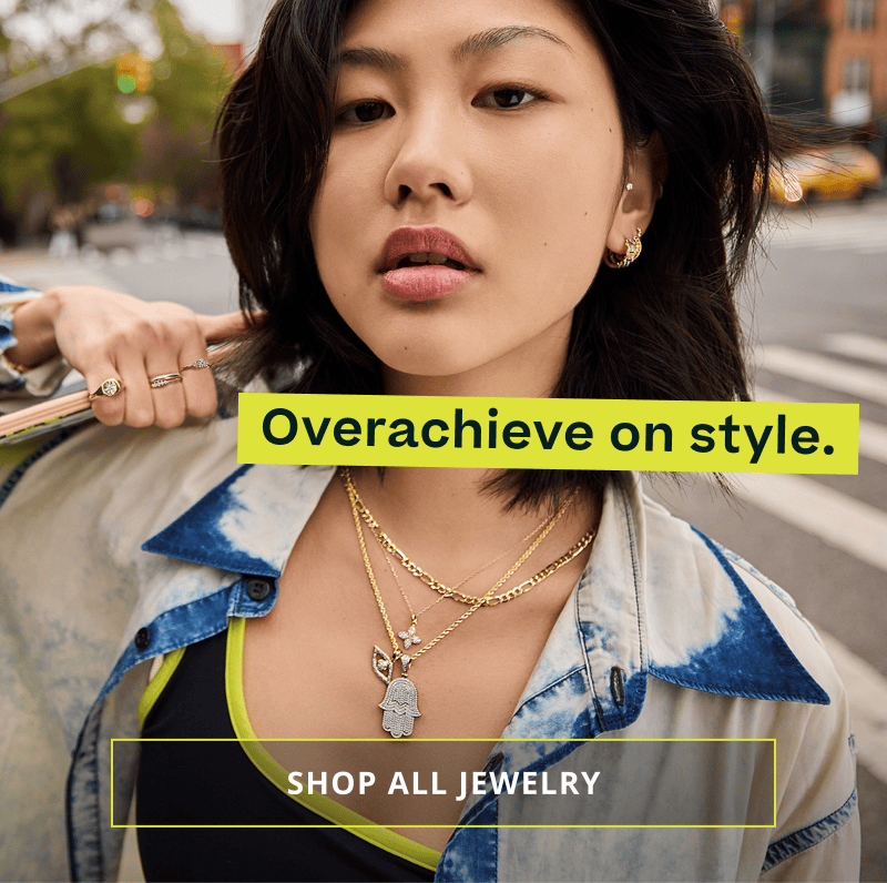 Model layered in gold chains with diamond pendants. Click here to shop all jewelry.