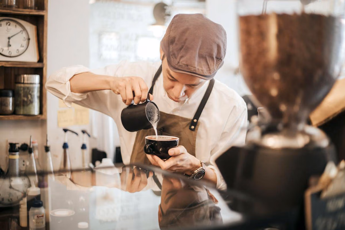 Peet's barista pouring espresso into a mug