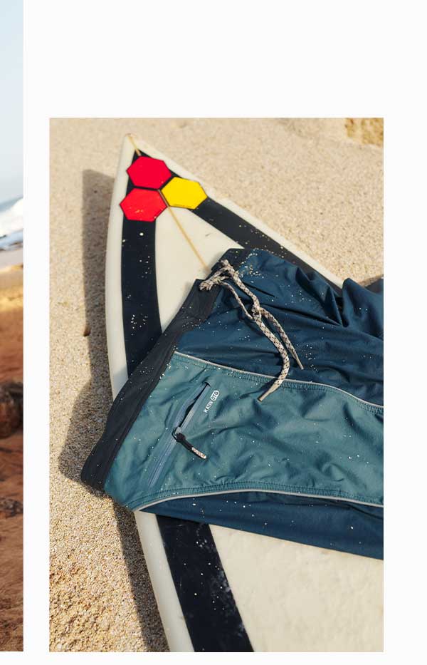 OTG Archer Surf Trunk laying wet on a surfboard